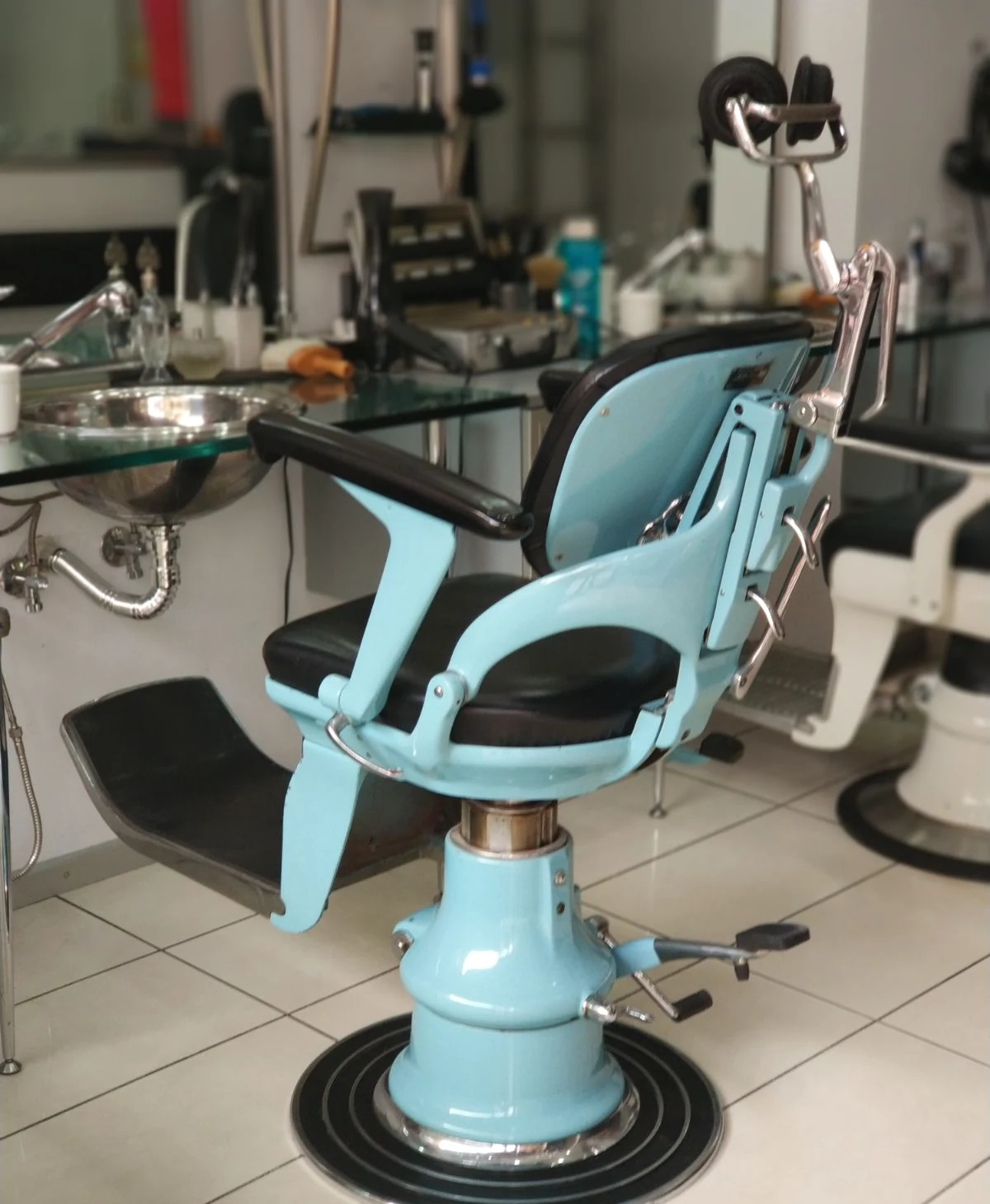 Vintage blue barber chair inside Rimedzo Barber Shop